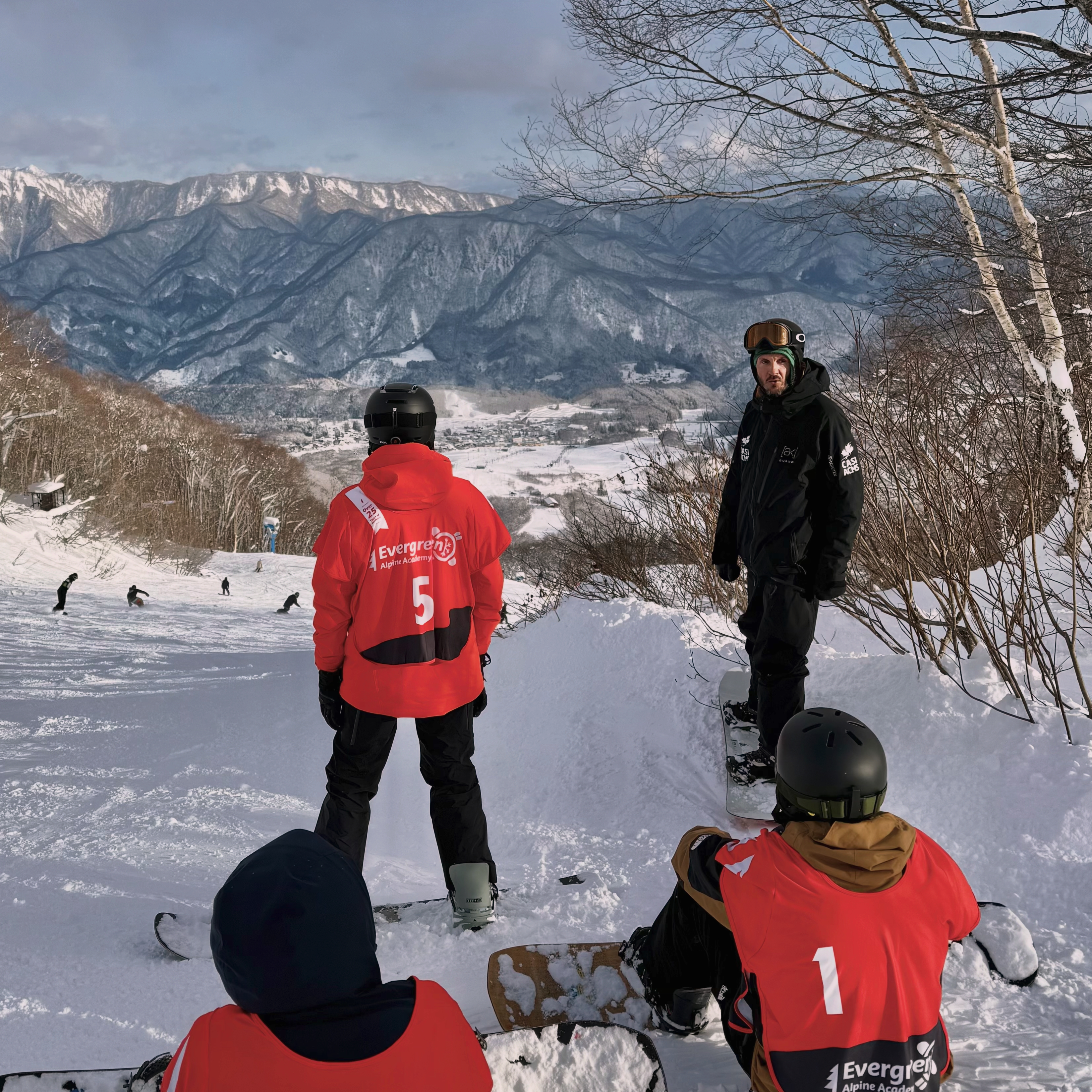 Kuba coaching a group of snowboard instructors on snow